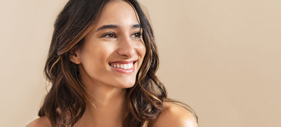 woman smiling after her facial plastic surgery in New Jersey