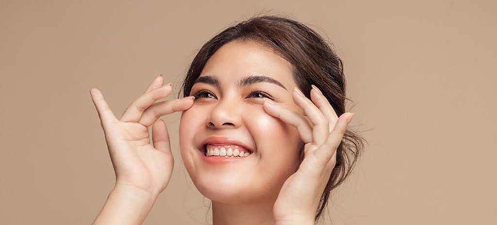 woman smiling after her lower blepharoplasty in New Jersey