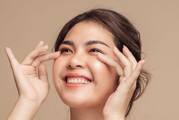 woman smiling after her lower blepharoplasty in New Jersey
