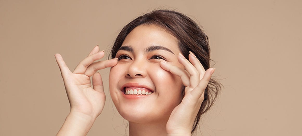 woman smiling after her lower blepharoplasty in New Jersey